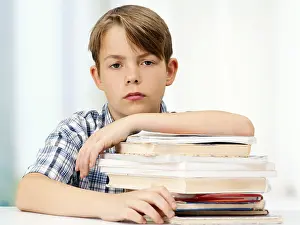 Caucasian Boy Portrait Impressions: Schoolboy with a stack of books, looking serious