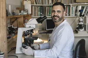 Scientist In Lab Impressions: Scientist in front of microscope