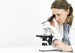 Virus Analysis Impressions: Scientist using microscope in laboratory
