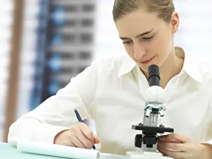 Female Scientist Microscope Impressions: Scientist working with a microscope