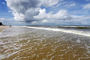 Uninhabited Beach Scene Impressions: Sea waves and dramatic clouds