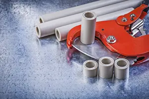 Metal Background Studio Shot Impressions: Set of pipe coupling tools on metallic background construction concept