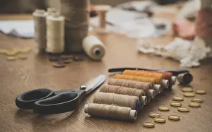 Woman At Work Impressions: Sewing concept. Scissors, threads and buttons