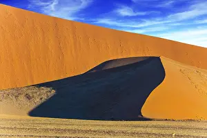 Namibia Landscape Impressions: Sharp border of light and shadow over the crest of the dune