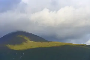 Deserted Highland Scenery Impressions: A single mountain covered by clouds