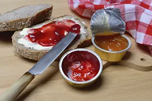 Aluminum Packaging Waste Impressions: Slice of bread with jam and jam in portion pack