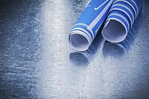 Blue Construction Plans Impressions: Stack of blue construction plans on metallic background building concept