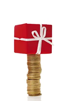 Christmas Gift Impressions: Stack of coins with gift parcel, present on top