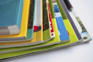 Magazine Stack Impressions: Stack of magazines on white background