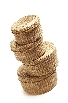 White Studio Backdrop Impressions: Stack of various sized wicker baskets isolated on white