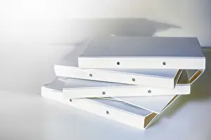 Office Productivity Tips Impressions: Stack of white file folder or ring binder waiting to be processed in an office
