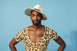 Blue Studio Photography Impressions: Stylish guy posing in studio against blue background looking at camera