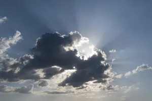 Cloudy Sky Impressions: Sun behind a cloud with rays of light