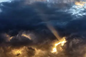 Dramatic Evening Sky Impressions: Sunbeam through gap in clouds, dramatic evening sky