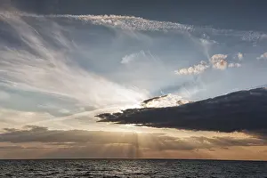 Evening Sun On The Sea Impressions: Sunbeams behind clouds, dramatic evening sky