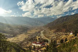 Cloudy Sunset Impressions: Sunrays through the clouds as the sun is setting over Paro
