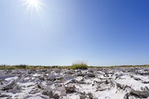 Namibia Desert Landscape Photography Impressions: Sunrays shine on drought mud patterns