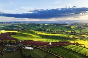 British Countryside Landscape Impressions: Sunset of Devon Windmill over Fields and Farms from a drone