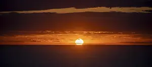 Deserted Beach Sunset Impressions: Sunset over the sea, with dramatic clouds