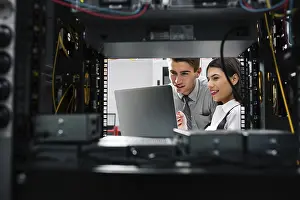Healthcare Technology Impressions: Team of technicians working together on servers at the data centre