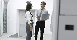 Server Room Technician Impressions: Technicians using laptop while analyzing server in server room