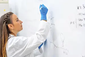 Caucasian Male Scientist Impressions: Side view of a scientist using a white board to write data