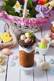 White Wooden Background Impressions: Top view small Easter cake decorated with nest and tiny eggs