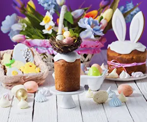 White Wooden Background Impressions: Top view small Easter cake decorated with nest and tiny eggs