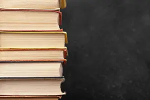 Book Stack Impressions: Front view stack different books with copy space