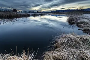 German Federal Republic Waterscapes Impressions: Water surface of the Ach with reflection and dramatic sky