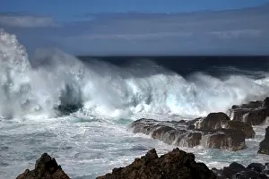 Rocky Coastline Impressions: Waves breaking thunderously on the sharp rocks of a cliff