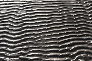Empty Beach Scene Impressions: Wavy pattern of sand on a beach