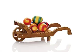 Traditional Easter Decoration Impressions: Wheelbarrow with colored easter eggs