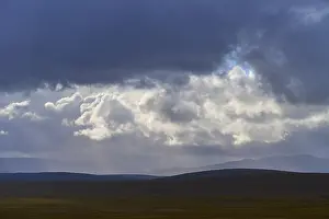 Scottish Upland Landscapes Impressions: Wide landscape under a sky full of dramatic clouds and rays of light