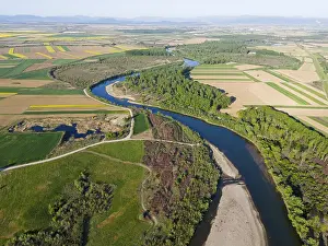 Agricultural Landscape Aerial View Impressions: A winding river, bordered by forests and fields