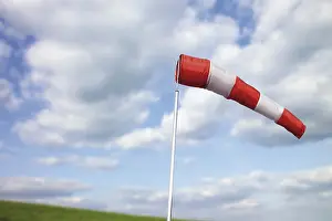 Cloudy Sky Impressions: Windsock in front of clouds in the sky