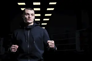Martial Arts Concept Impressions: Young kickboxer posing in the studio