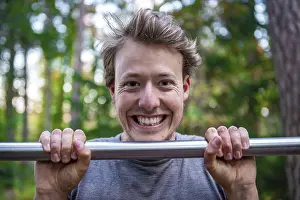 Athletic Male Portrait Impressions: Young man doing pull-ups on a pull-up bar