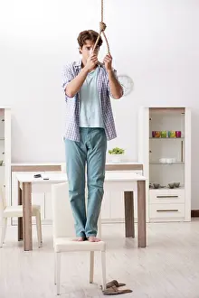 Young Adult Depression Impressions: Young man preparing to commit suicide by hanging