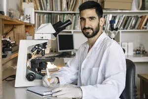 Medical Diagnosis Process Impressions: Young scientist in front of microscope